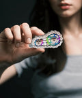 Close-up of woman holding Bike Chain Gear Fidget Spinner Metal EDC Toy For Stress Relief And Focus in hand, showing details.