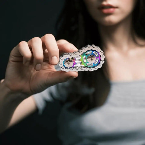 Close-up of woman holding Bike Chain Gear Fidget Spinner Metal EDC Toy For Stress Relief And Focus in hand, showing details.