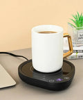 Keep Your Daily Drip Stayin Toasty With This Electric Coffee Mug Warmer Featuring Three Custom Temperature Levels Four Hour Auto Shut Off And Compact Desk Base For Zero Cold Sip Regrets with white mug on black warmer.