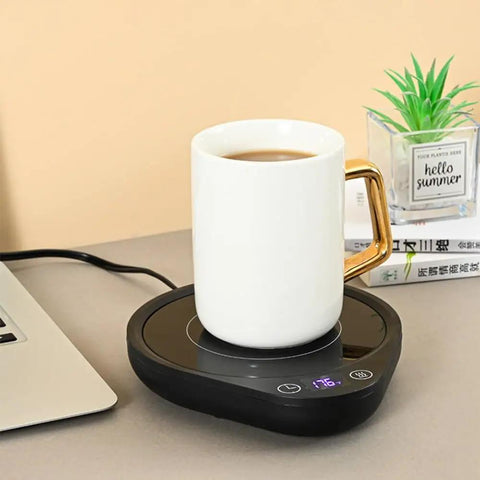 Keep Your Daily Drip Stayin Toasty With This Electric Coffee Mug Warmer Featuring Three Custom Temperature Levels Four Hour Auto Shut Off And Compact Desk Base For Zero Cold Sip Regrets with white mug on black warmer.