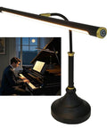 Black and gold Wide 21.26 Inch Piano Lamp with LED light panel, eye-caring, touch dimmer, placed next to a man playing piano.