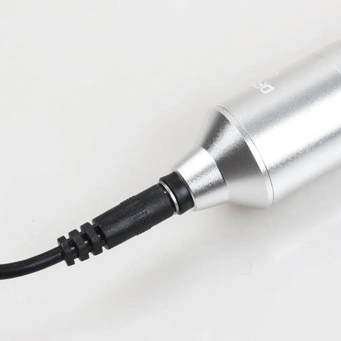 Close-up of Universal DC Power Cord for Tattoo Machines with Pen Rotary Systems connected to a device, durable connector.