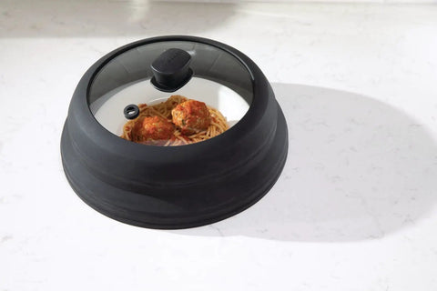Mess Free Microwave Splatter Cover With Foldable Design for quick cleanup, covering spaghetti dish, black silicone and glass design