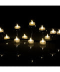 24 Pack Flickering LED Tea Lights With Timer 6 Hour Auto On Off Battery Operated Flameless Tealights glowing on holders