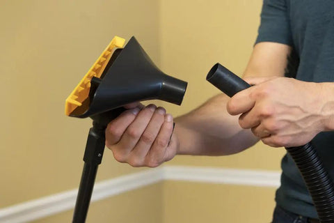 Person connecting Popcorn Ceiling Scraper Vacuum Attachment for Shop Vacuums, Acoustic Texture Removal Tool pole and hose.