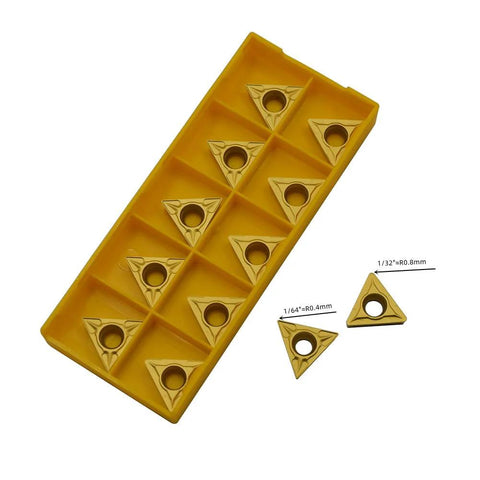 Twenty carbide turning inserts in a yellow plastic storage tray; triangular with center holes (TCMT32.51/32.52/16T304/16T308)