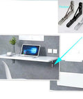 Heavy Duty Stainless Steel L Shaped Shelf Brackets With Corrosion Resistant Wall Supports For Kitchen And Bedroom Storage Built Tough To Hang Your Gear With Ease Rock Solid Folding Mounts That Save Space, supporting a floating desk with a laptop.