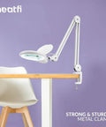 LED Bifocal Magnifying Lamp With 1,200 Lumens, Dual 2.25X And 6X Magnification on table, adjustable arm with clamp