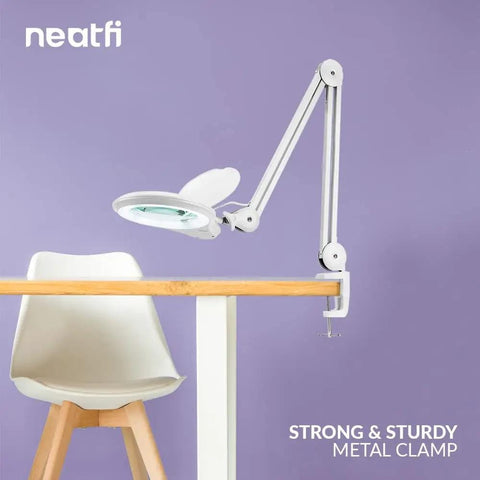 LED Bifocal Magnifying Lamp With 1,200 Lumens, Dual 2.25X And 6X Magnification on table, adjustable arm with clamp