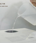 Portable Countertop Dishwasher With Built In Water Tank pouring water into built-in 5 liter tank, showcasing easy refilling.