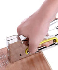 Heavy Duty Sofa Staple Gun With Adjustable Lever And Push Button Slot For Quick Loading in use on wood surface.