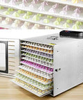 Top Shelf Heavy Duty Ten Layer Stainless Steel Electric Food Dehydrator With Digital Timer And Adjustable Trays For Making Jerky Fruits Vegetables And Pet Snacks, open with colorful trays.
