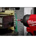 Milwaukee cordless impact driver side view driving a bit into an electrical panel terminal block