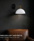 Industrial Dome Wall Sconce, White, 180° Adjustable Vintage Wall Light mounted above a brown leather chair on a dark wall.