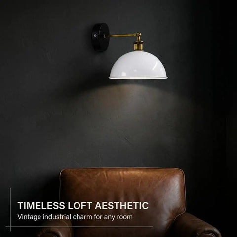 Industrial Dome Wall Sconce, White, 180° Adjustable Vintage Wall Light mounted above a brown leather chair on a dark wall.