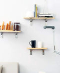 Heavy Duty Folding Triangle Brackets 4 Pack Wall Mounted Shelf Supports Sturdy Stainless Steel Space Saver with books and kitchen supplies.