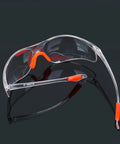 Four Pack Real Deal Fogless Safety Glasses With Thick Padding And Rounded Edges Windproof Splash Goggles in clear with orange accents.