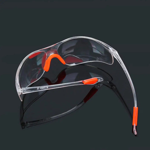 Four Pack Real Deal Fogless Safety Glasses With Thick Padding And Rounded Edges Windproof Splash Goggles in clear with orange accents.