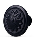 Close-up of matte black round cabinet knob with floral design, part of Matte Black Round Cabinet Knobs 10 Pack Zinc Alloy With Floral Design 1.4 Inch Diameter Drawer Knobs With Included Screws For Cabinets And Dressers Dope Hardware To Level Up Your Furniture