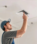 No Sweat 8X8 White Plastic Access Panel With Door, 6.5 Inch Opening being installed by a worker in a ceiling.