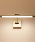 Awesome Adjustable Dimmable LED Picture Light With Swing Arm In Brushed Nickel illuminating wall in warm white