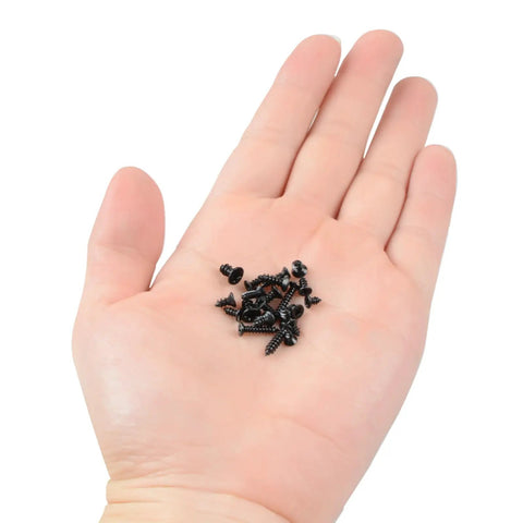 Hand holding black screws from 300 Piece Black Laptop Screw Replacement Kit With Countersunk Self Tapping Screws KA2 KA2.6 KA3