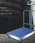 Heavy Duty Digital Platform Scale With Slick Folding Design And Compact Storage For Weighing Luggage And Shipping Boxes Up To Three Hundred Kilos Featuring Quick Lbs Kgs Switch And Direct Reading Price Calculator with blue platform and sturdy frame