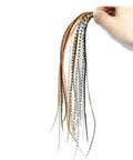 Hand holding Rooster Saddle Fly Tying Feathers Pack For Midge And Dry Fly Hackle, mixed colors, ideal for trout fishing.
