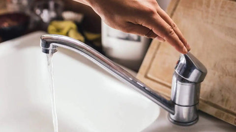 Hand turning on water with Two Pack Chrome Faucet Aerators 2.2 GPM Dual Thread For Male And Female Faucets Standard Size
