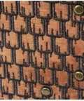 Close-up of Miniature Structure Brads 100 Piece Set Durable Metal Fasteners on black and brown textile pattern.
