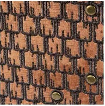 Close-up of Miniature Structure Brads 100 Piece Set Durable Metal Fasteners on black and brown textile pattern.