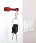 10 Pack Keychain Magnets for Gold and Jewelry Testing with red key holder on white wall