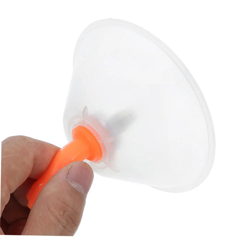 Hand holding a Two Pack Transparent Windproof Spray Nozzle Cover with orange handle for garden hose or backpack sprayer.