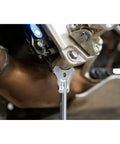 Close-up of Beefy Adjustable Motorcycle Stand For Maintenance And Service 11 To 19 Inch Lift zinc plated steel in use on motorcycle.