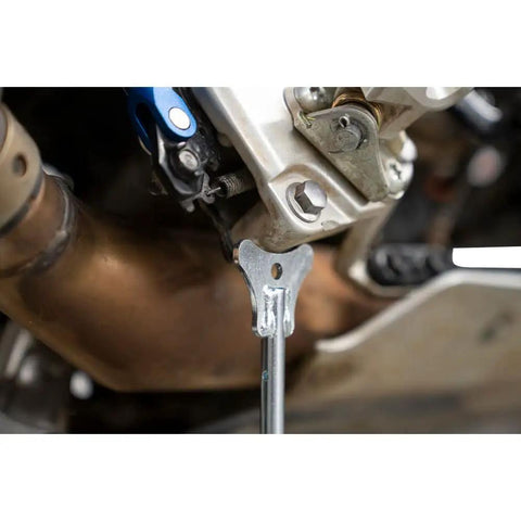 Close-up of Beefy Adjustable Motorcycle Stand For Maintenance And Service 11 To 19 Inch Lift zinc plated steel in use on motorcycle.