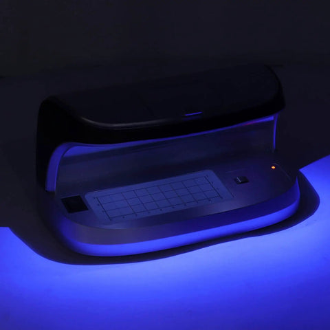 High Speed Money Counter With UV MG WM MGF Detection And Built In Magnifier Scale Banknote Verifier For US Dollars Euros Pounds Yuan And More Quick Counterfeit Check For Retail Cash Rooms Cashier Friendly in dark blue light.