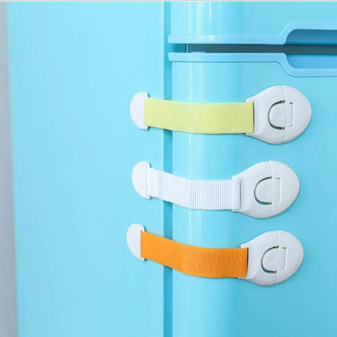 10 Pack Kid Proof Safety Locks For Cabinets And Drawers No Tools Needed Self Adhesive Refrigerator Locks in assorted colors on blue fridge