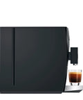 Top Shelf Automatic Coffee Machine In Sleek Piano Black featuring freshly brewed espresso in a glass cup on the counter.
