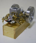 Kickstart Your Engineering Quest With This Slick Six Cubic Centimeter Hit And Miss Gasoline Engine featuring brass components on wood base.