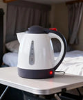 12V Car Electric Kettle With Auto Shut Off Portable Water Heater For Long Distance Runs And Weekend Getaways Direct Socket Insert on a table.