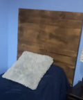No Brainer Walnut Aging Wood Stain In 5 Gallon Pails transforms rough cut lumber into a warm brown headboard in bedroom.