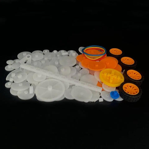 Assorted components of the 164 Piece Plastic Gear Set For RC Cars And DIY Robots, featuring gears, belts, and wheels.