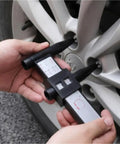 Hands using 8-Lug Hub Bore Caliper with Digital LCD for Wheel Inspection on a silver wheel, measuring hub bore.