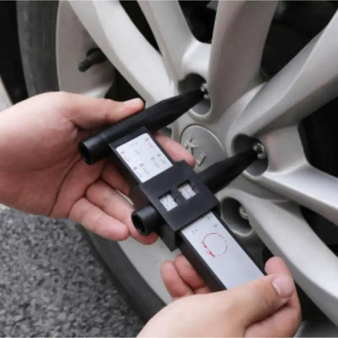 Hands using 8-Lug Hub Bore Caliper with Digital LCD for Wheel Inspection on a silver wheel, measuring hub bore.