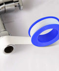 30 Roll Pack Of PTFE Thread Seal Tape One Half Inch By Three Hundred Ninety Four Inches White Teflon Pipe Sealant Tape For Leak Proof Plumbing Water Lines And Air Lines DIY Plumbers shown wrapped around a metal pipe fitting.