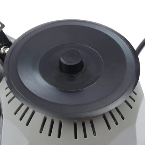 Close-up of carousel round tape dispenser on automatic ribbon cutting machine with adjustable 6 to 60 mm cutting length and 3 to 25 mm tape width.