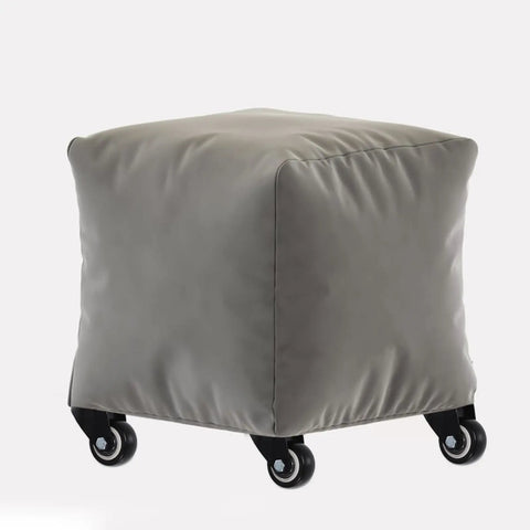 2 Inch Swivel Caster Wheels With Side Mount Hardware Glides Smooth As Butter For Cabinets Drawers And Shop Carts Quiet Polymer Rollers Built Tough To Last on a gray cushioned stool.