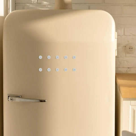 Beige retro-style refrigerator with metal handle in a modern kitchen setting.