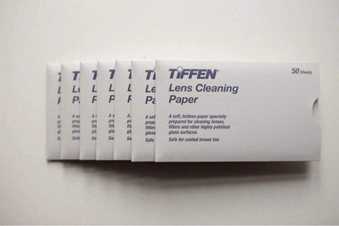 Front view of white Tiffen Lens Cleaning Paper boxes, 50 sheets each; multiple boxes shown.