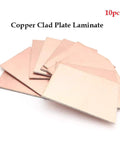 Ten Pack 1.6mm Thick Copper Clad Plate Laminate PCB For Etching DIY Projects FR4 Glass Fiber 100 X 150Mm Single Or Double Sided Sets Ideal For Prototyping Education And Hobbyist Electronics Experiments. Stack of ten copper clad PCB plates for DIY electronics, 100x150mm, shown fanned out on white background.